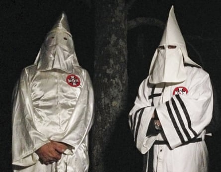 Two masked Ku Klux Klansmen giving an interview to the Associated Press near Pelham, North Carolina on the night of 2 December.