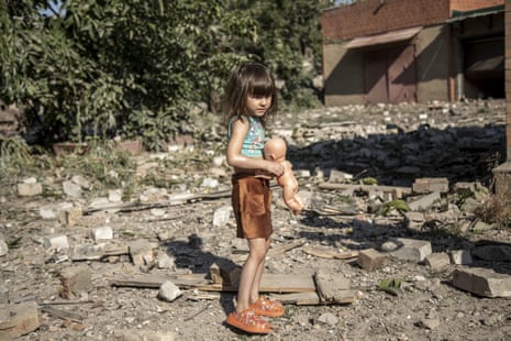 A child walks on the debris left by an explosion following a missile strike on a civilian neighbourhood in Bakhmut, near Sloviansk, Ukraine.