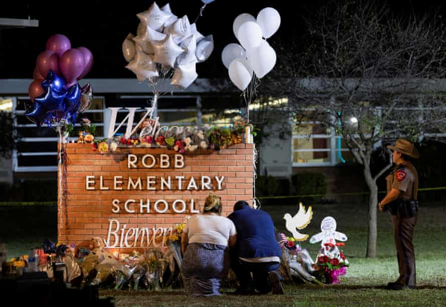 Stephanie and Michael Chavez of San Antonio pay their respects outside Robb elementary school.