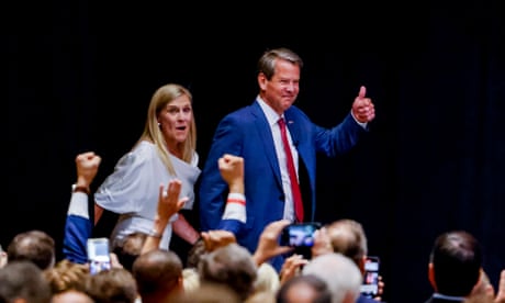 Republican Georgia Governor Brian Kemp at a primary election returns party<br>epa09973488 Republican Georgia Governor Brian Kemp (R) and his wife Marty (L) react with supporters during a primary election returns party at the College Football Hall of Fame in Atlanta, Georgia, USA, 24 May 2022. Kemp easily defeated former Senator David Perdue and will face Democratic challenger Stacey Abrams in the November general election. EPA/ERIK S. LESSER