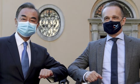 China’s foreign minister, Wang Yi and the German foreign minister, Heiko Maas, touch elbows. They are both wearing face masks