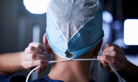 Surgeon tying surgical cap