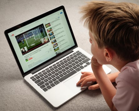 Child watching YouTube videos on a laptop