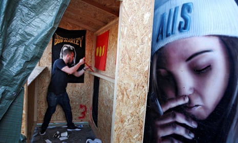 A man demolishes a marijuana stall in Christiania