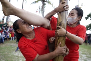 Jakarta, Indonesia. People celebrate independence day by climbing a pinang tree on Ancol beach