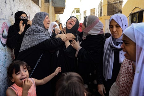 Women mourn during the funeral of members of the Abu Quta family who were killed in Israeli strikes on the Palestinian city of Rafah in the southern Gaza Strip.