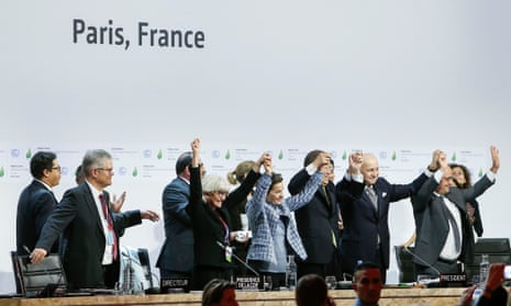 World leaders celebrate the adoption of a climate agreement during the Paris talks earlier this month.