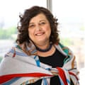 A woman smiles at the camera