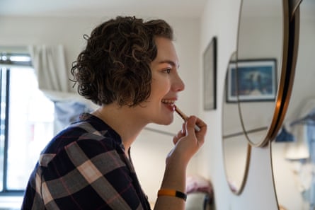 Emily Holden, the environment reporter for The Guardian US, puts on makeup at her apartment in Washington, DC.