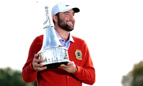 Scottie Scheffler holds the trophy and wears the winner’s cardigan at Bay Hill