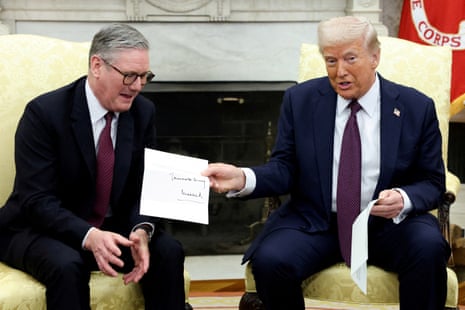 Donald Trump holds a letter from King Charles which was delivered by UK prime minister Keir Starmer when they met in the Oval Office at the White House in Washington DC in February 2025.