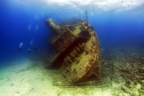 Scuba divers approach the stern of the Giannis D shipwreck at Shaab Abu Nuhas in the Red Sea Straits of Gubal, Egypt