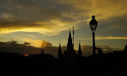 cathedral and lamp silhouetted by sunset