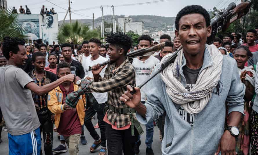 A soldier of Tigray Defence Force (TDF) greets a man as soldiers are welcomed by people on a street in Mekelle.