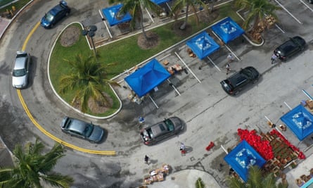An aerial view of vehicles passing through as they receive food from a food bank in Sunrise, Florida, on 6 April.