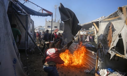Smoke rises from the fire as Palestinians attempt to extinguish fire broke out after Israel targets displaced Palestinian tents in Deir al-Balah, Gaza on 09 November 2024. It was reported that the Israeli army targeted the tents of displaced civilians within the compound of the Aqsa Martyrs hospital in Deir al-Balah, located in the central Gaza Strip. (Photo by Ashraf Amra/Anadolu via Getty Images)