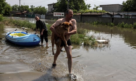 Local residents help save animals from a flooded area of Kherson, Ukraine after the dam was breached.