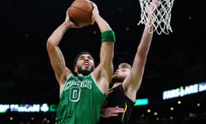 Celtics forward Jayson Tatum (left) was one of 15 players ruled out of Monday night’s Boston-Minnesota game for virus-related reasons alone. He jumps towards the net.