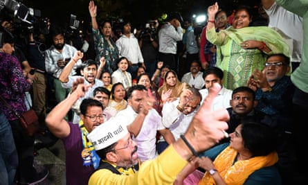 Aam Aadmi party members protest as officers arrive to arrest Arvind Kejriwal at his residence in Delhi.