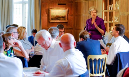 Theresa May speaks to members of her cabinet at Chequers.