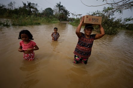 Villagers wade in flood water in the typhoon-hit town of Buguey, Cagayan province