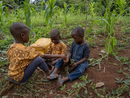 Three of Tralou Trana Jeanette’s six grandchildren sat in a field