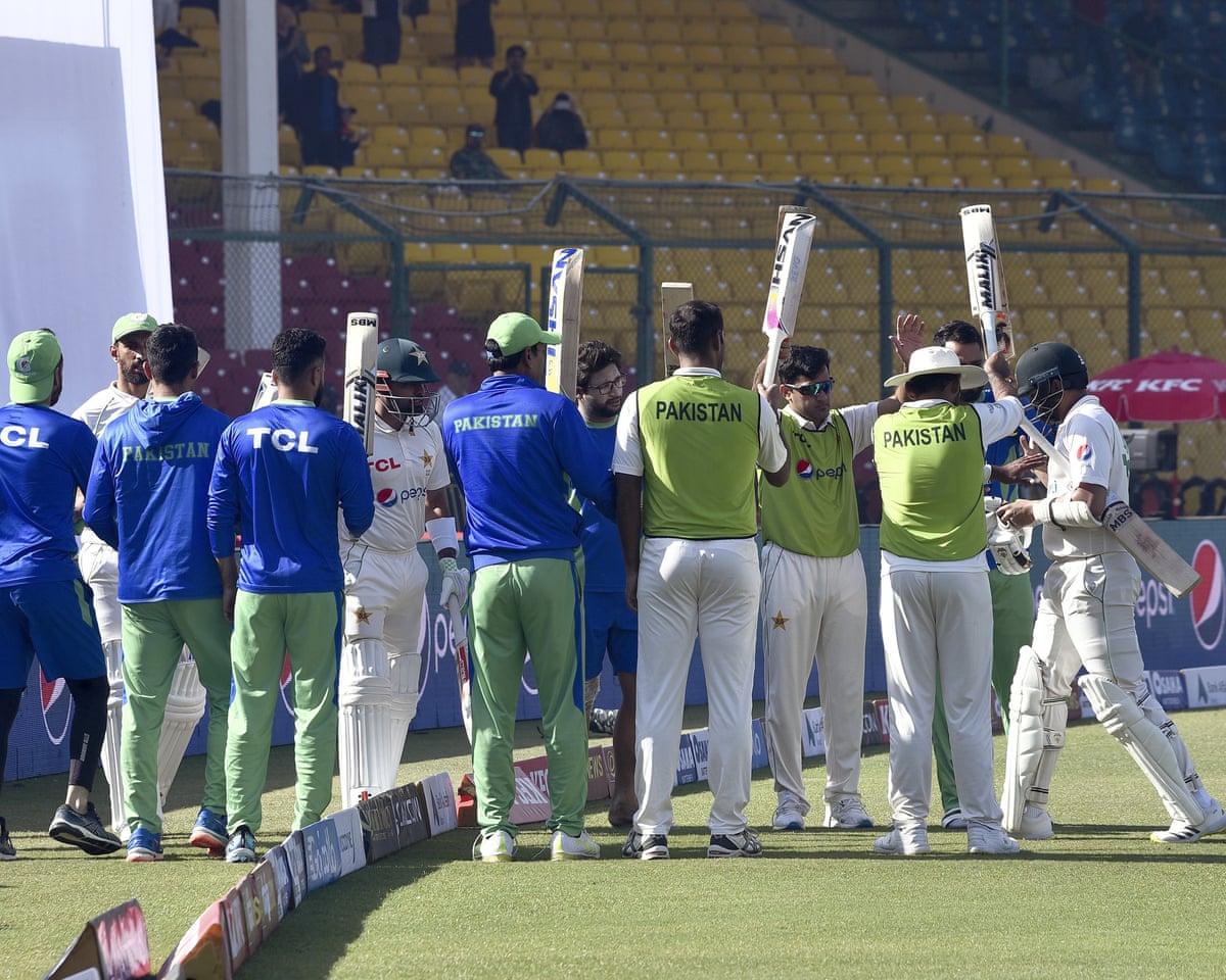 The Pakistan players raise their bats to give a guard of honour to their teammate Azhar Ali, who has just finished his final innings in Test cricket before retiring.