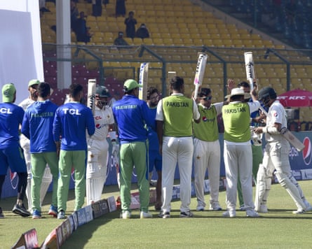 The Pakistan players raise their bats to give a guard of honour to their teammate Azhar Ali, who has just finished his final innings in Test cricket before retiring.