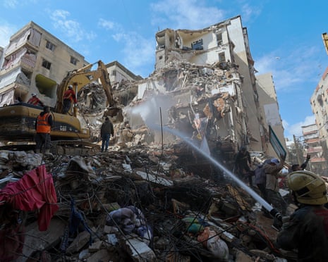 First responders clear the rubble of a partially destroyed building targeted by an Israeli air strike, in the densely populated Hay el-Sellom neighborhood in the southern suburbs of Beirut, on Friday.