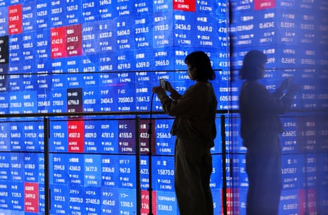 An electronic screen displaying Japan's Nikkei stock prices quotation board today