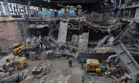 People walk among twisted wreckage