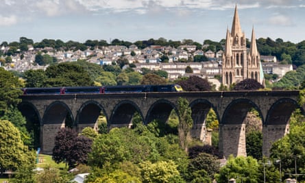 A train crosses Carvedras viaduct in front of Truro cathedral in 2022