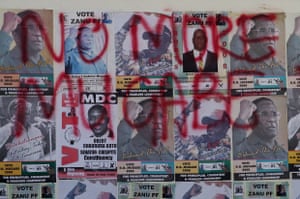 Mugabe election posters of are covered in opposition MDC slogans, in Harare, 2008.