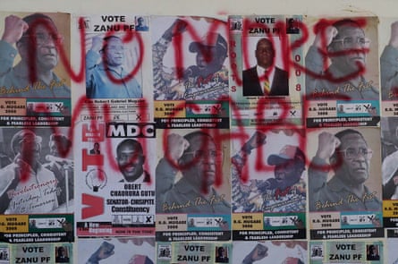 Mugabe election posters are covered in opposition MDC slogans, in Harare, 2008.