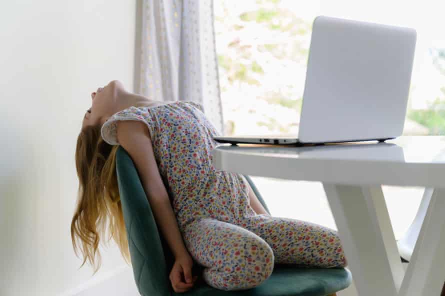 Girl leaning back on chair while remote learning