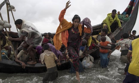 Rohingya Refugees Flood Into Bangladesh<br>DAKHINPARA, BANGLADESH - SEPTEMBER 12:  Rohingya  refugees jump from a wooden boat as it begins to tip over after travelling from Myanmar, on September 12, 2017 in Dakhinpara, Bangladesh. Recent reports have suggested that around 290,000 Rohingya have now fled Myanmar after violence erupted in Rakhine state. The 'Muslim insurgents of the Arakan Rohingya Salvation Army' have issued statement that indicates that they are to observe a cease fire, and have asked the Myanmar government to reciprocate.  (Photo by Dan Kitwood/Getty Images)