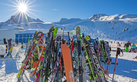 Skis and snowboards stored on racks in the Austrian Alps