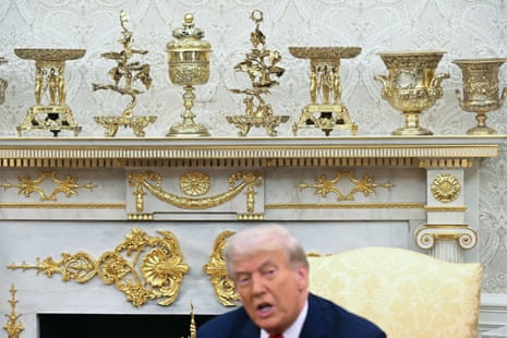 Top of Trump's head below gold decor on mantel
