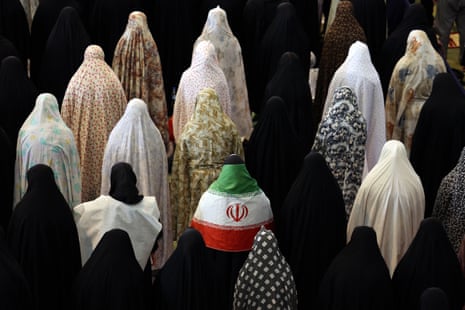 Iranian Shia women, including one covered with the Iranian national flag, take part in Eid al-Fitr prayers at the Grand Mosalla mosque in Tehran.