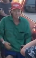 Young white man in green shirt and red cap
