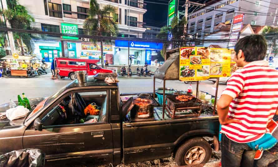 A car modified to also be a food cart serves dishes on Nimmanhaemin Road, in Chiang Mai, Thailand