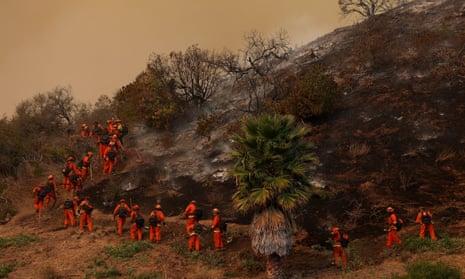 Inmate firefighters dig a containment line as they battle the Palisades Fire on January 10, 2025 in Los Angeles, California. The Palisades fire had grown to over 22,000 acres and has destroyed thousands of homes. The fire is currently 11 percent contained. (Photo by Justin Sullivan/Getty Images)