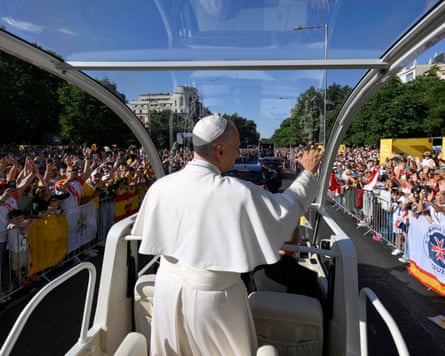 Pope Leo waves to crowds from the popemobile