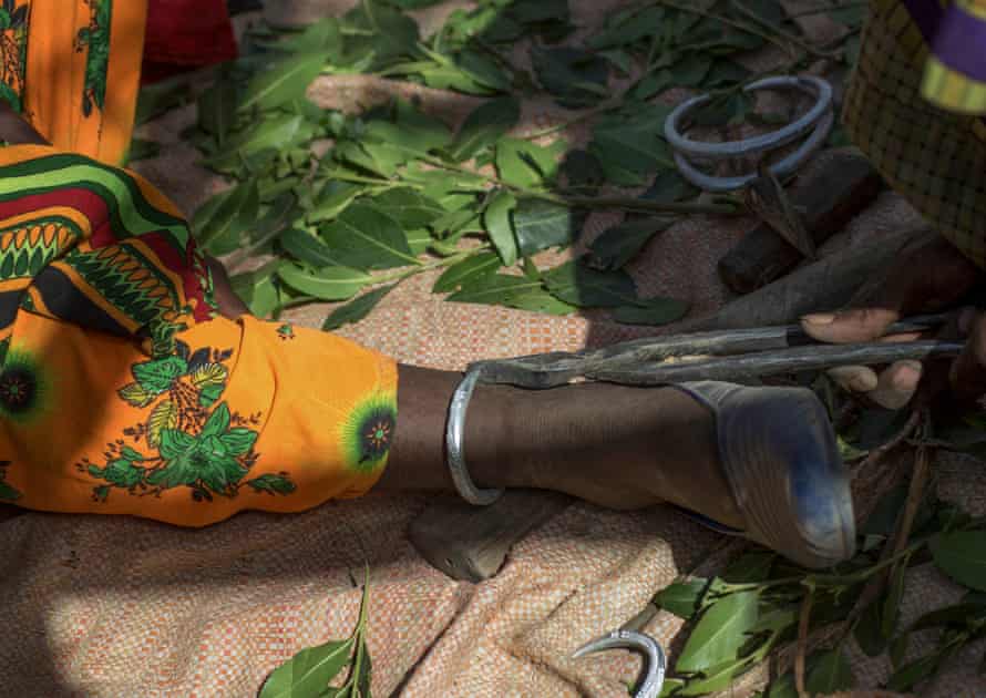 A blacksmith puts an ankle bracelet on a girl before a wedding in Metahara, Oramia district.