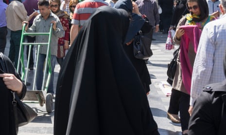 Covered woman wearing chador and hijab downtown Tehran.