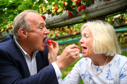 Liberal Democrat leader Ed Davey and MP Tessa Munt feed each other a strawberry