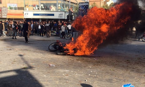 Iranian protesters clash in the streets following a fuel price increase in Isfahan, central Iran