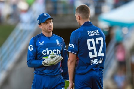 Brydon Carse consults with the England captain Jos Buttler in Antigua.