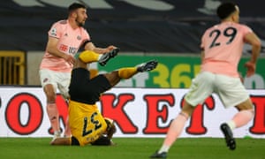 Wolverhampton Wanderers’ Adama Traore lands heavily after going up for a header with Sheffield United’s Enda Stevens.