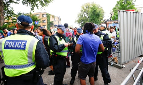 Police stop and search people during the Notting Hill Carnival.